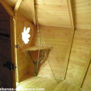 Cabane en bois à lIle-de-France, avec une fenêtre en forme de feuille.