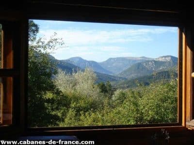 Cabane en bois avec vue panoramique sur les montagnes dAuvergne-Rhône-Alpes.