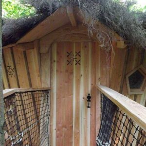 Cabane en bois avec toit végétal, nichée dans la verdure de lAuvergne.