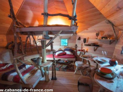 Cabane en bois dans le Grand-Est, intérieur chaleureux avec lits superposés et décor naturel.