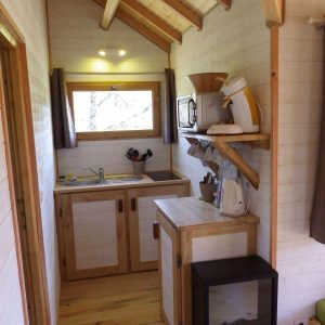 Cabane en bois en Aquitaine, avec cuisine équipée et lumière naturelle.