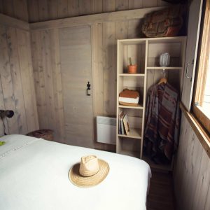 Chalet en bois chaleureux avec lit douillet et décoration naturelle.