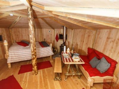 Cabane en bois cosy en Auvergne, avec lit douillet et décor chaleureux.