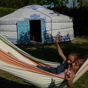 Yourte colorée en Provence-Alpes-Côte dAzur, enfants se relaxant dans un hamac.