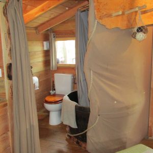 Cabane en bois en Bretagne avec salle de bain et décoration chaleureuse.