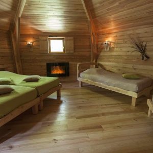 Chalet en bois chaleureux avec lits confortables et ambiance cosy à Auvergne-Rhône-Alpes.