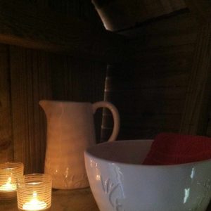 Hébergement insolite en Île-de-France : coin détente avec bougies et vaisselle en céramique.