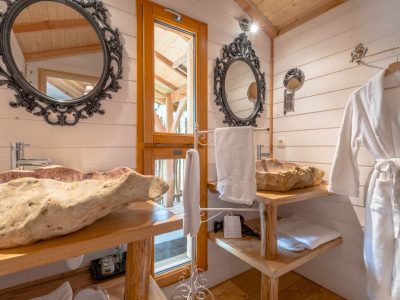 Salle de bain dun hébergement insolite en Aquitaine, avec lavabo en pierre naturelle.