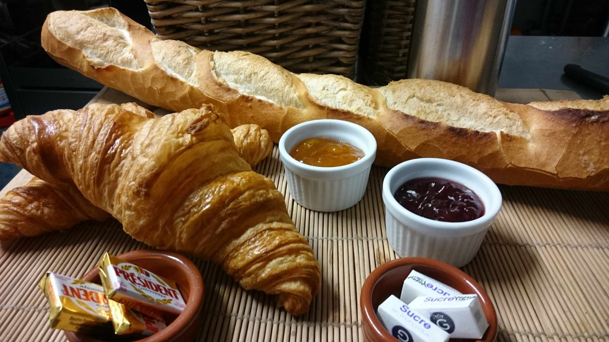 DSC_1257 Petit-déjeuner gourmand avec croissant, baguette et confitures dans un hébergement insolite.