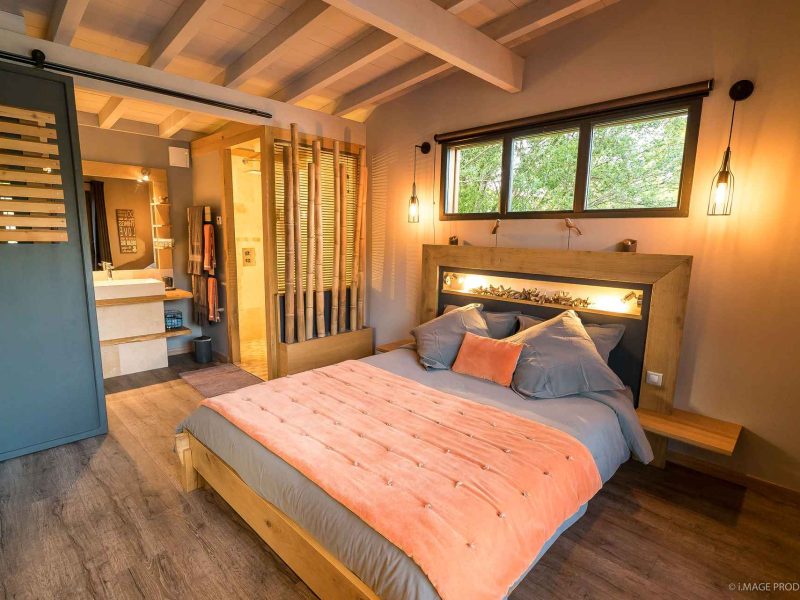 Chambre dhôtes moderne avec lit douillet et décoration chaleureuse.