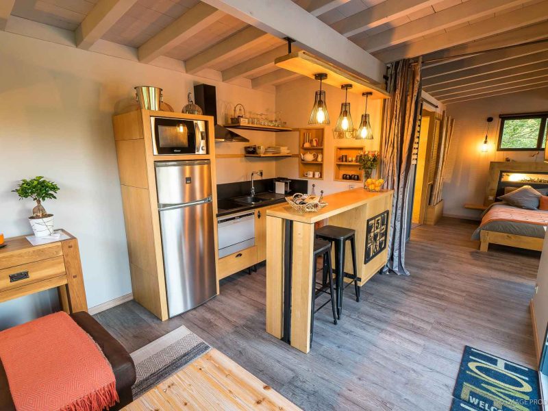 Chalet moderne avec cuisine équipée et décoration chaleureuse en bois.