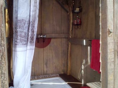 Douche en bois dans un hébergement insolite en Aquitaine, ambiance nature et chaleureuse.