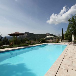 Hébergement insolite en Auvergne-Rhône-Alpes avec piscine et vue panoramique sur les montagnes.