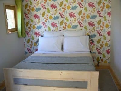 Chambre dhôte insolite à Limousin, décor floral coloré et lit en bois confortable.
