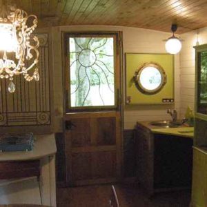 Hébergement insolite en Bourgogne : intérieur cosy avec lustre et cuisine colorée.