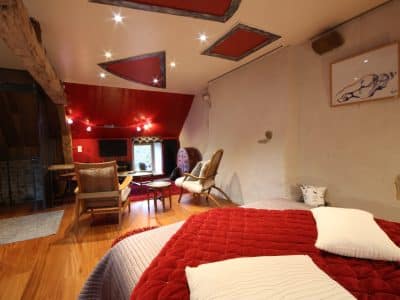 Hébergement insolite en Basse-Normandie, chambre avec murs en pierre et décor moderne.