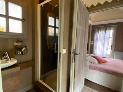 Hébergement insolite en cabane, avec salle de bain moderne et décoration chaleureuse.