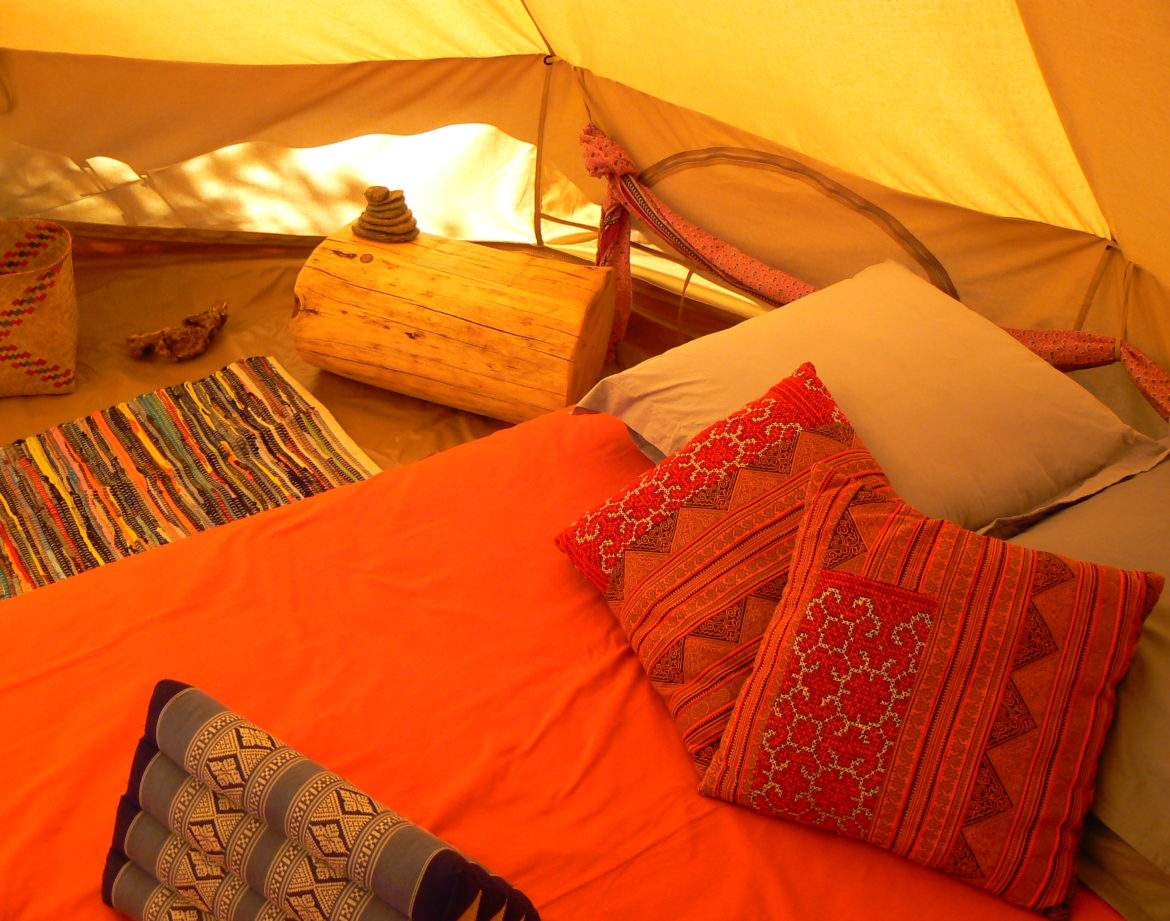 Tente confortable en Languedoc-Roussillon, avec un lit douillet et des coussins colorés.