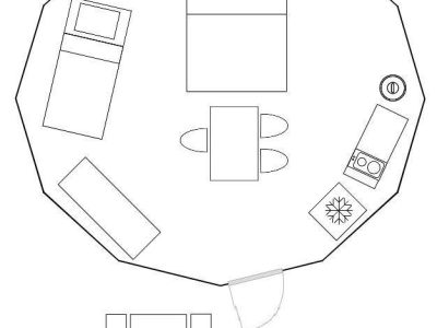 Hébergement insolite en Auvergne : un espace octogonal de 18 m² avec lit double et coin cuisine.