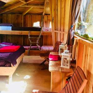 Cabane en bois à Basse-Normandie, avec lit double et décor chaleureux.