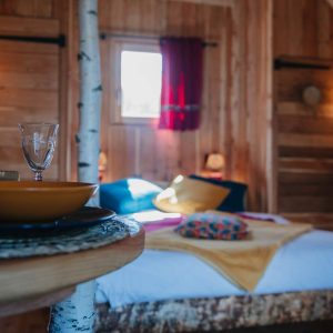 Chalet en bois chaleureux avec lit douillet et décor naturel à Provence-Alpes-Côte dAzur.