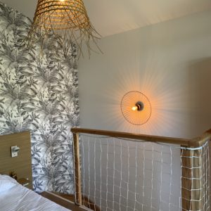 Hébergement insolite en Aquitaine : chambre avec décoration moderne et luminaires en osier.