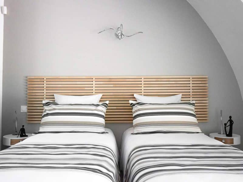 Chambre dhôtes moderne avec lits jumeaux et décor épuré en bois.