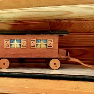 Hébergement insolite : une charmante roulotte en bois avec fenêtres colorées.