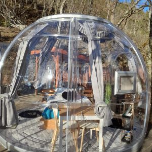 Hébergement insolite en bulle transparente, offrant une vue imprenable sur la nature.