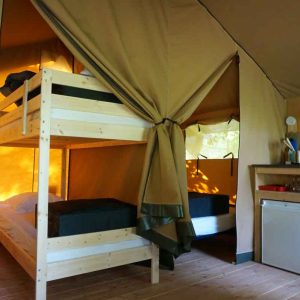 Tente safari confortable avec lits superposés et kitchenette, idéale pour un séjour insolite.