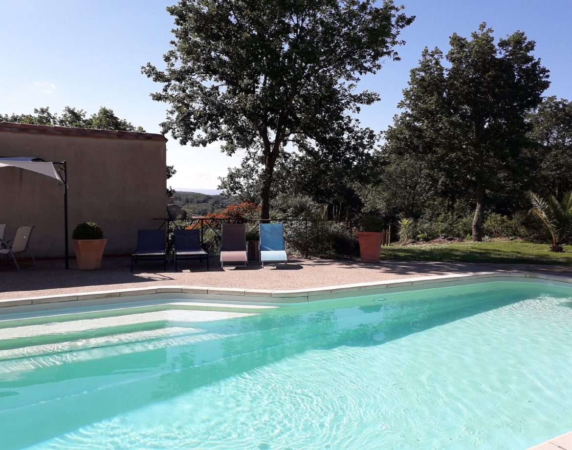 Hébergement insolite avec piscine, entouré de verdure et darbres en Languedoc-Roussillon.