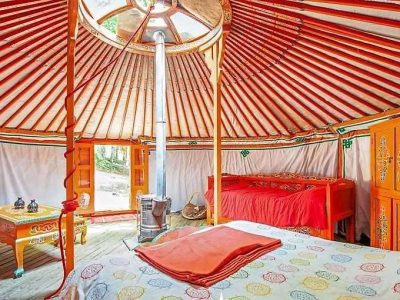 Yourte colorée en Auvergne, avec lits douillets et décor traditionnel vibrant.