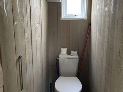 Toilettes en bois dans un hébergement insolite à Pays de la Loire, ambiance naturelle.