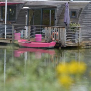 Hébergement insolite en Bourgogne : un bateau-hôtel avec une terrasse sur leau.