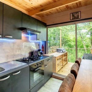 Hébergement insolite en Midi-Pyrénées : cuisine moderne avec vue sur la nature verdoyante.
