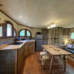 Cabane en bois dans les Midi-Pyrénées, avec cuisine équipée et décor naturel.