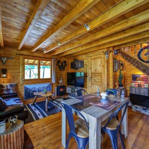 Chalet en bois chaleureux avec un intérieur rustique et des fenêtres lumineuses.