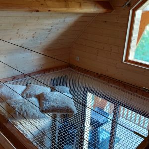 Cabane en bois avec un espace mezzanine et de confortables coussins.