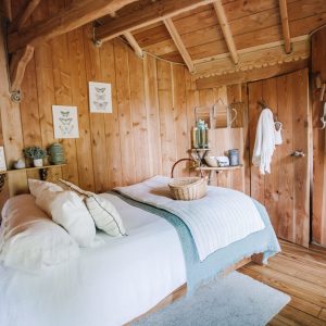 Chalet en bois chaleureux avec lit douillet et décoration naturelle à Pays de la Loire.