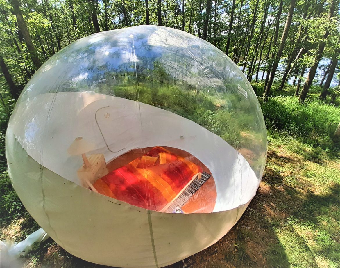 Hébergement insolite en bulle transparente, entouré de verdure en Auvergne.