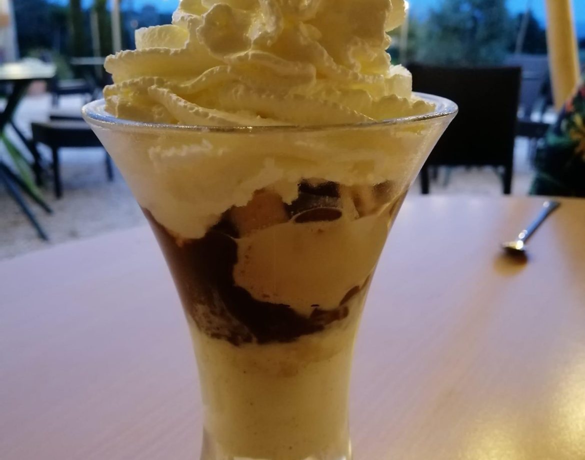 Dégustation dune coupe glacée crémeuse sous les guirlandes lumineuses en Languedoc-Roussillon.
