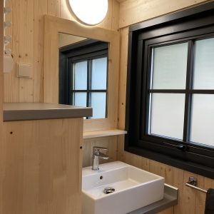 Salle de bain moderne en bois dans un hébergement insolite à Languedoc-Roussillon.