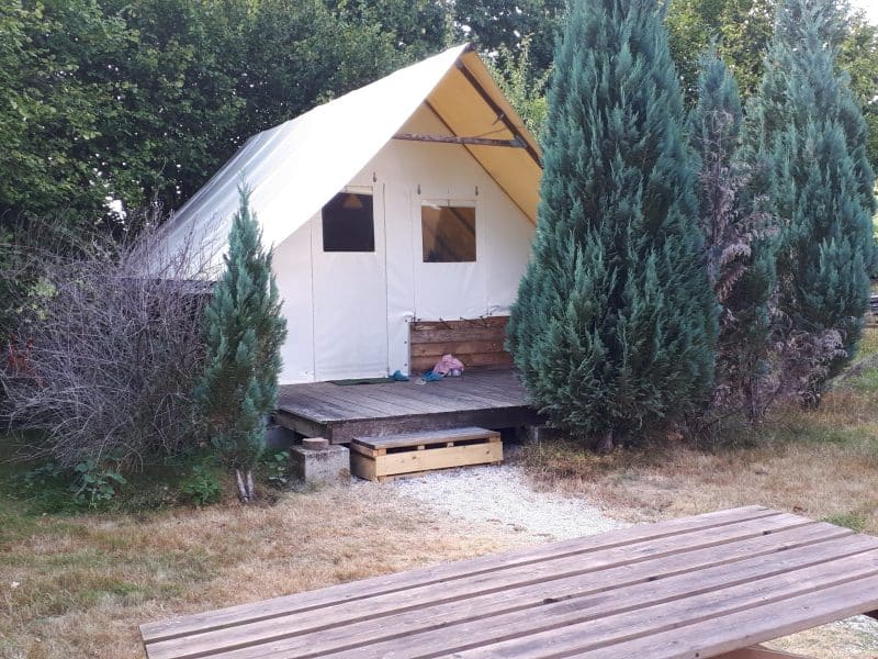 Tente safari cosy à Grand-Est, entourée de verdure et dun espace extérieur accueillant.
