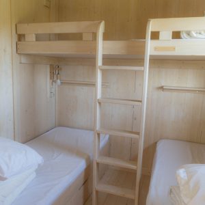 Chalet en bois en Bretagne avec lits superposés et ambiance chaleureuse.