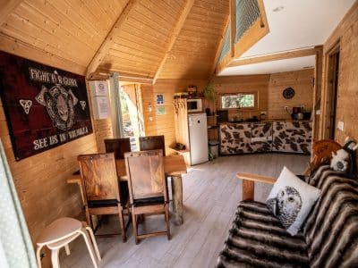 Cabane en bois en Bretagne, intérieur chaleureux avec meubles en bois et décor animalier.