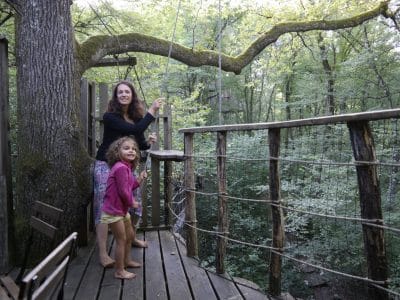 Cabane dans les arbres en Bourgogne-Franche-Comté, entourée de verdure et de nature.