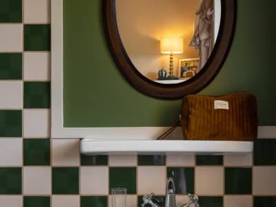 Hébergement insolite en Aquitaine : salle de bain vintage avec carrelage bicolore.