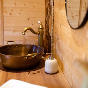Élégant hébergement insolite en Auvergne-Rhône-Alpes avec lavabo en cuivre.