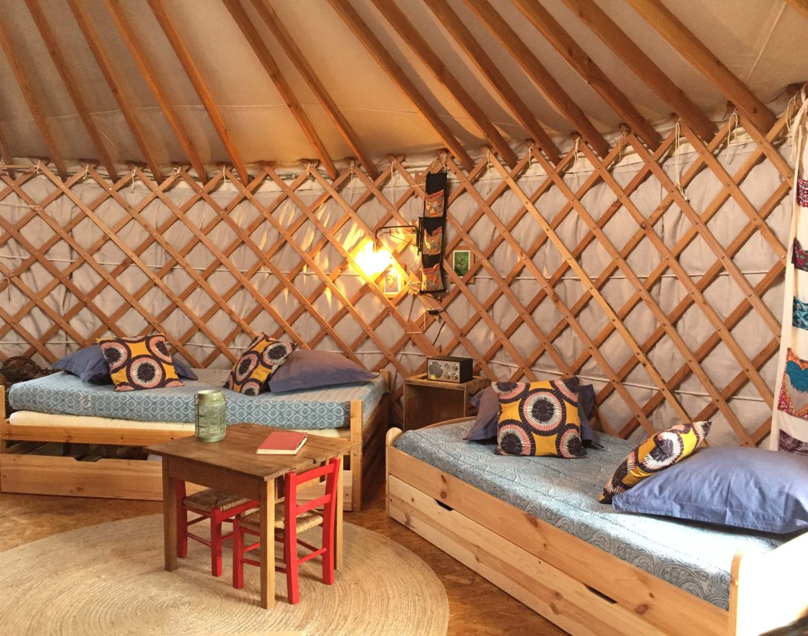 Yourte confortable en Auvergne, avec lits douillets et décor coloré.