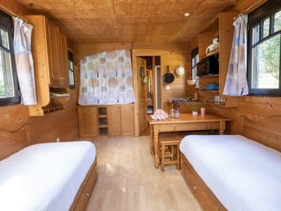 Hébergement insolite en Auvergne : chalet en bois lumineux avec deux lits simples.